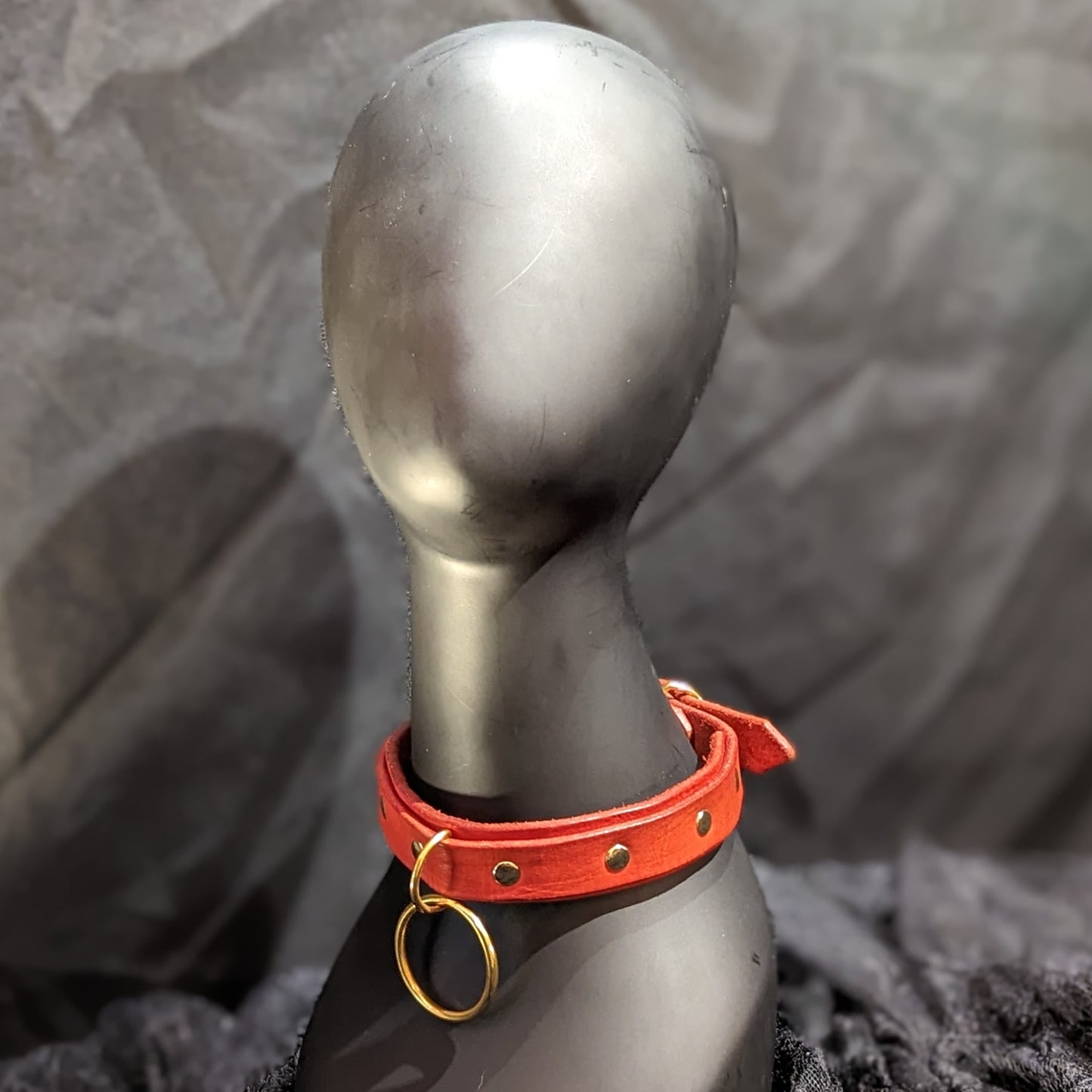 Red leather collar by Smell My Leather. This collar has two layers of leather and a dangling 1.5" O-ring. The hardware color is gold