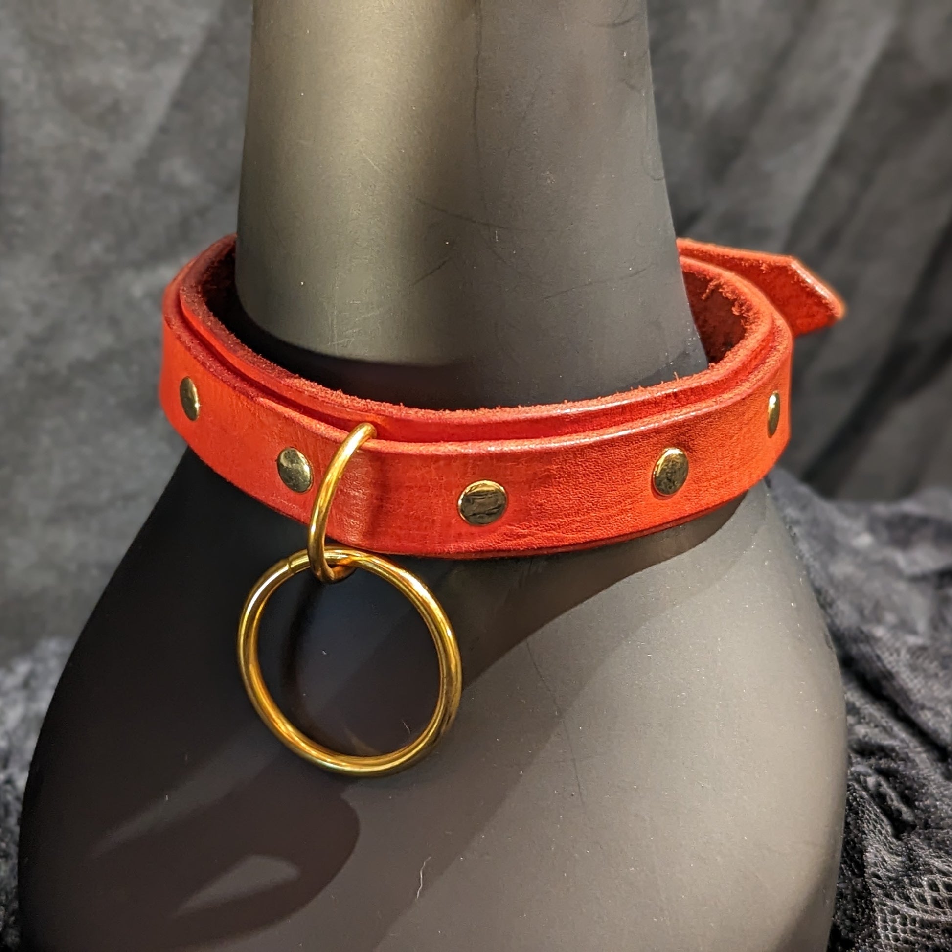 Red leather collar by Smell My Leather. This collar has two layers of leather and a dangling 1.5" O-ring. The hardware color is gold