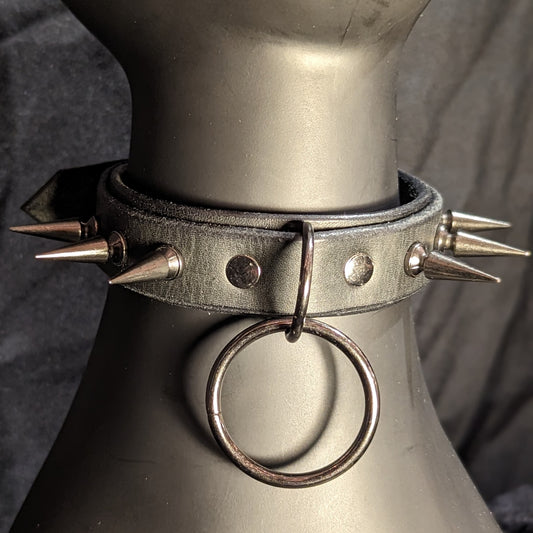 Black spiked collar by Smell My Leather. This collar has two layers of leather with 1" spikes and gunmetal hardware